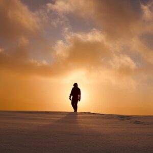 a person walking across a snow covered field